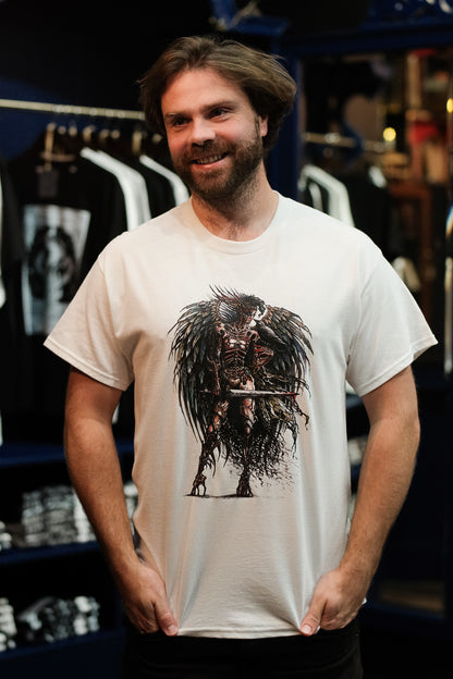 Man wearing a white t-shirt with a graphic design of Celtic Goddess The Morrigan in a store setting
